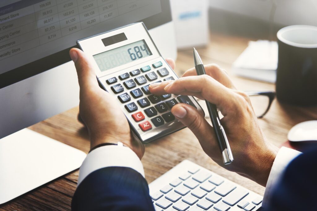 Man using a using a calculator at his desk.