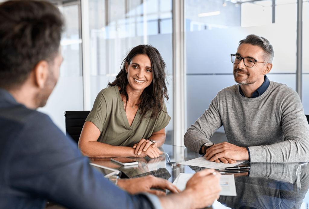 Business partners dicussing private loan options with their lender.